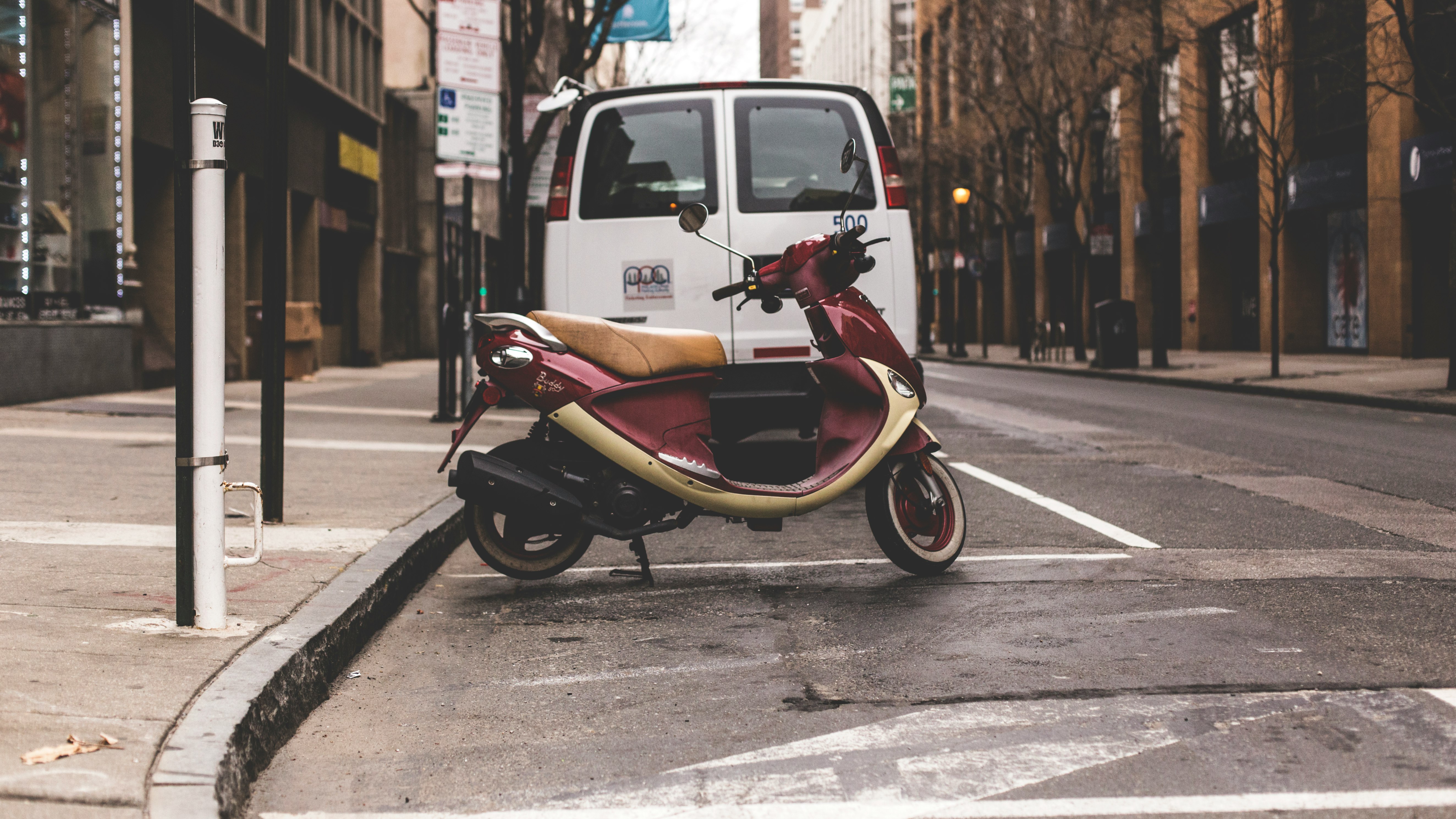 red and beige motor scooter